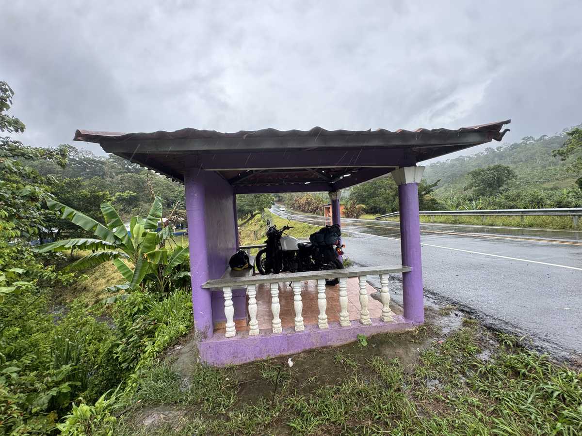 Waiting out the rain under a roadside shelter, Honduras